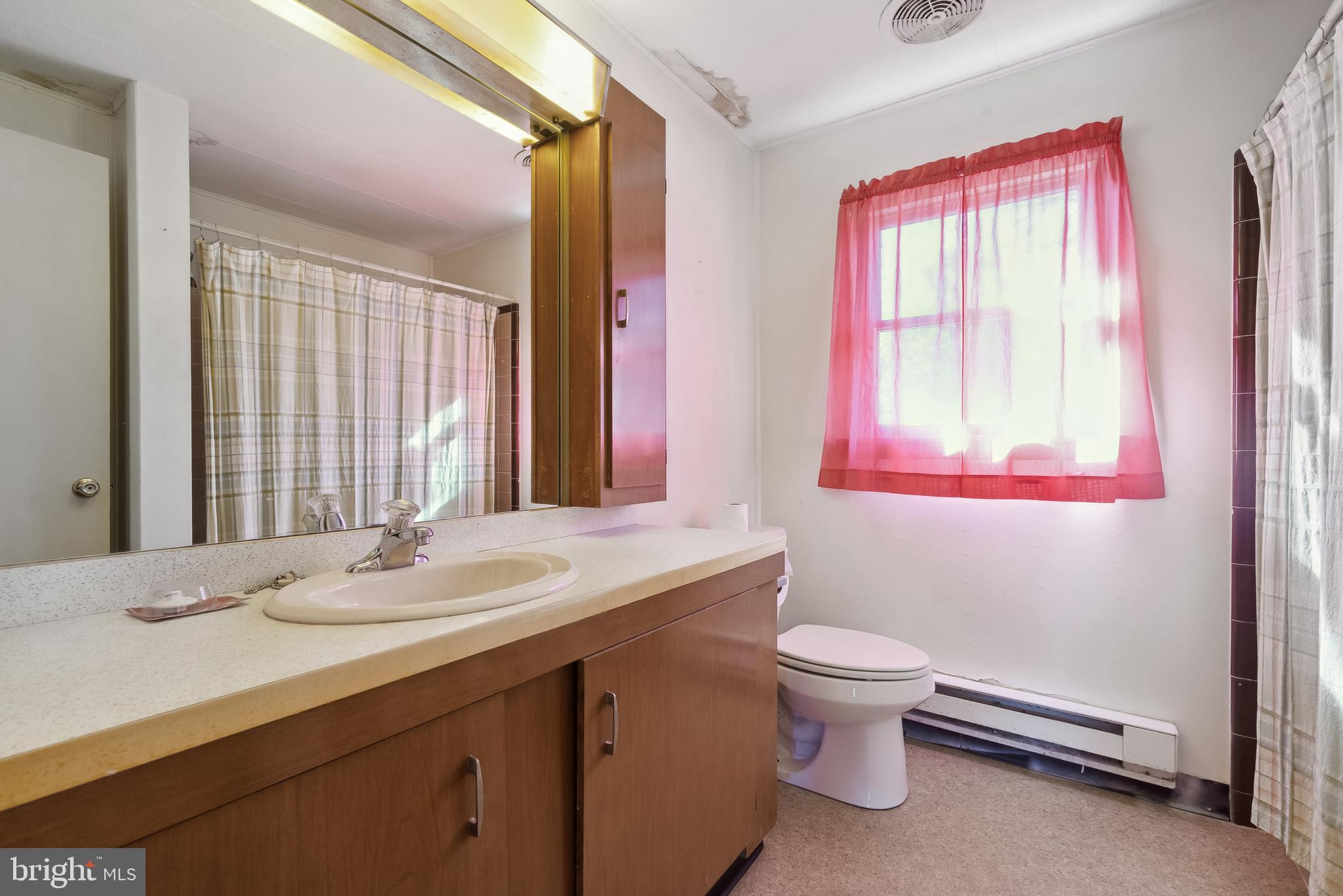 1106 Round Top Road Chestertown, MD 21620 - Photo 13 of 27 a bathroom with a granite countertop sink toilet and large mirror