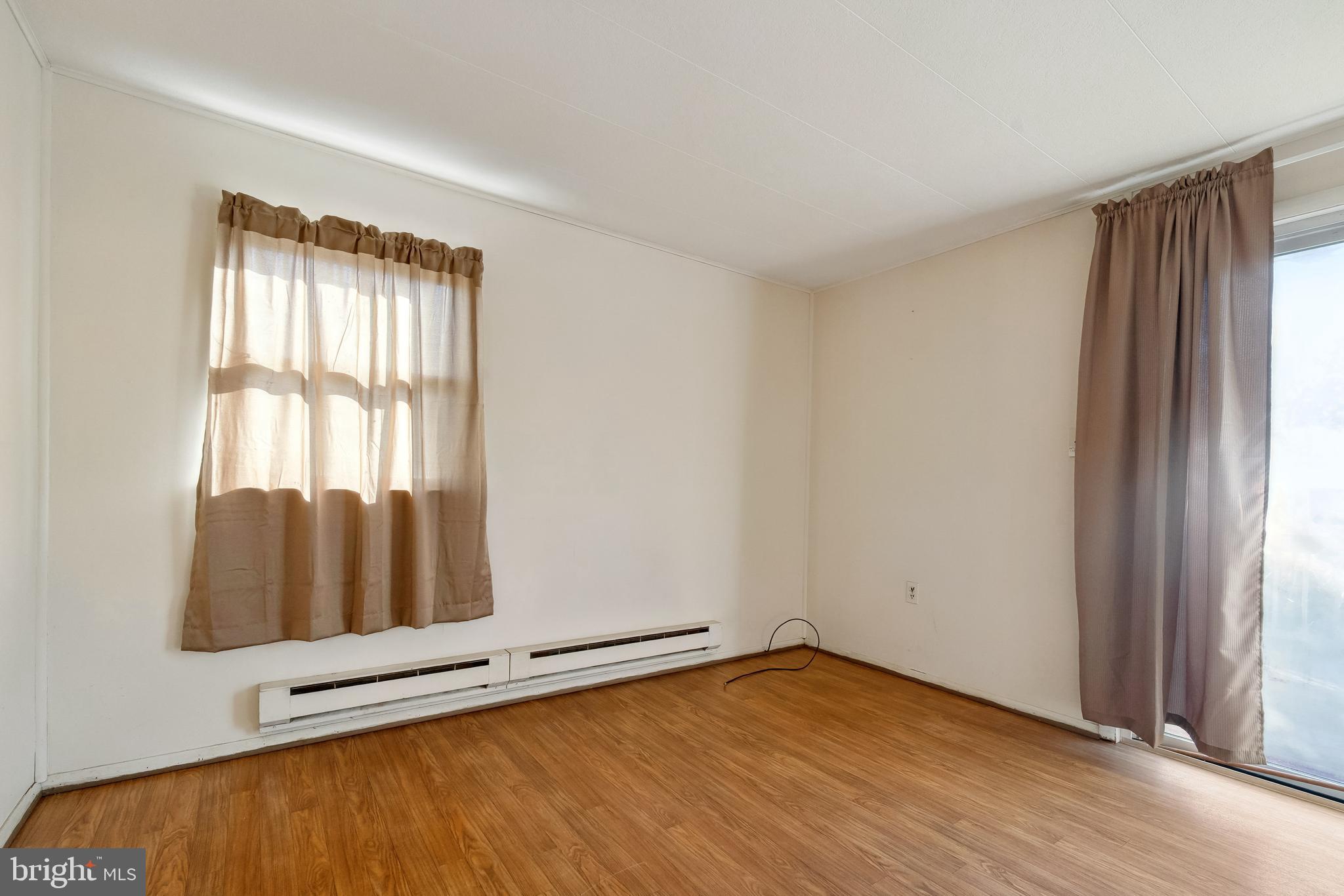 1106 Round Top Road Chestertown, MD 21620 - Photo 16 of 27 an empty room with wooden floor and windows