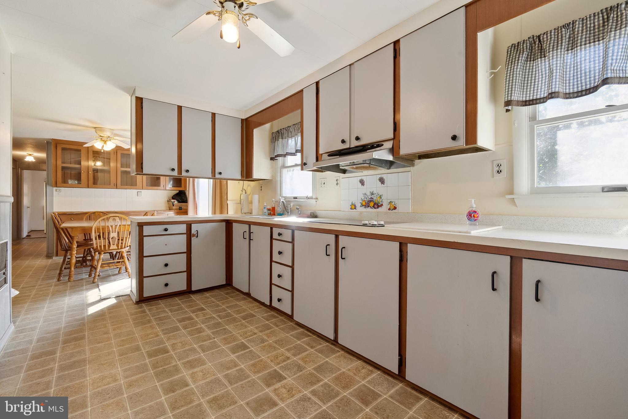 1106 Round Top Road Chestertown, MD 21620 - Photo 5 of 27 a kitchen with stainless steel appliances a sink a stove a refrigerator cabinets and a window