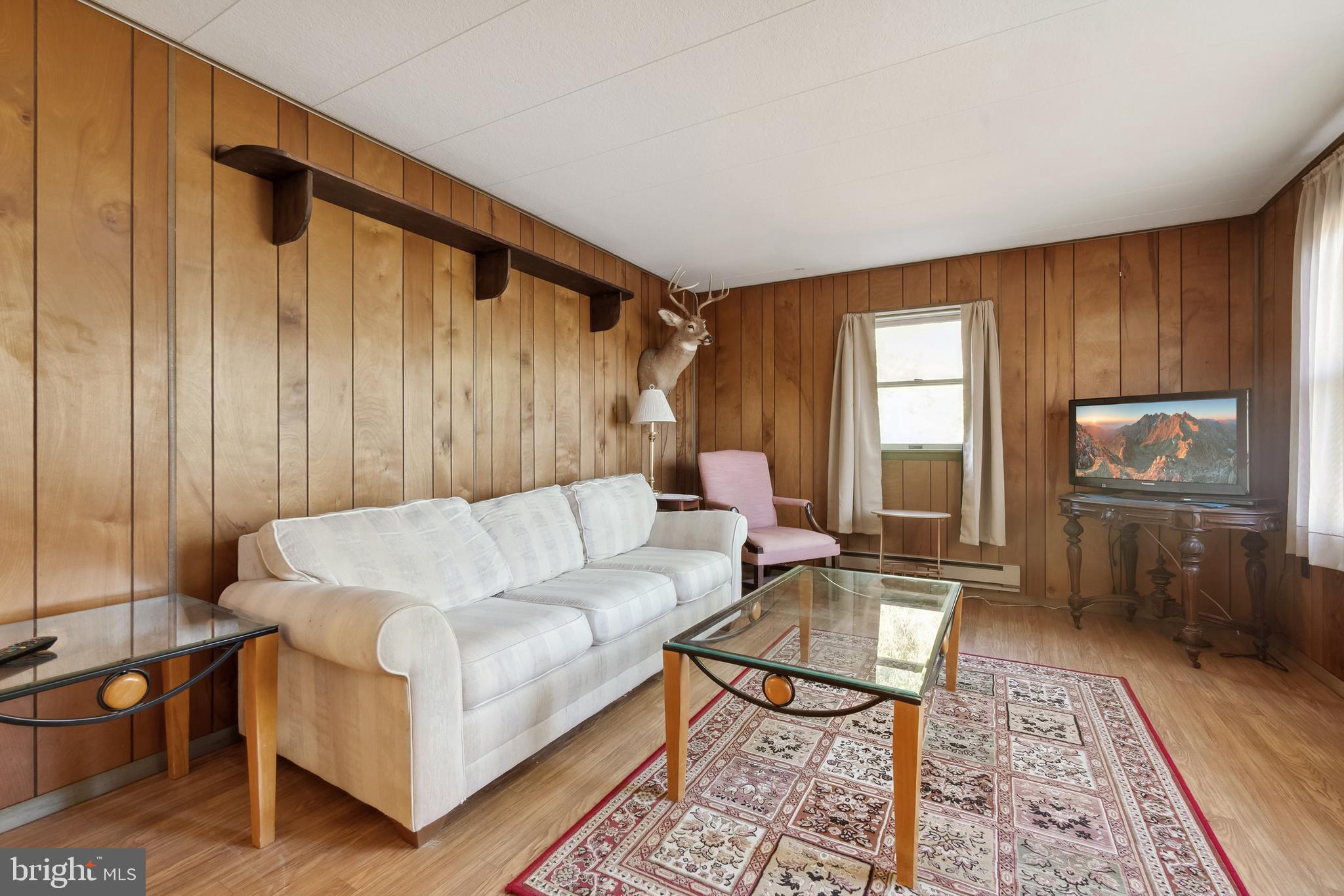 1106 Round Top Road Chestertown, MD 21620 - Photo 8 of 27 a living room with furniture a wooden floor and a table
