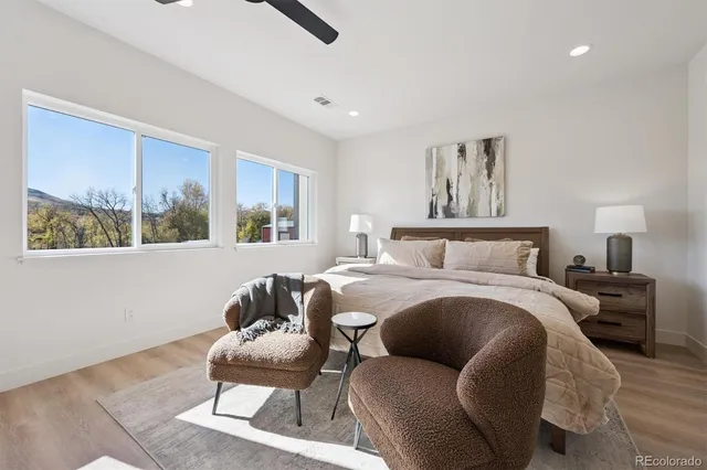 a bed room with a bed and a chair