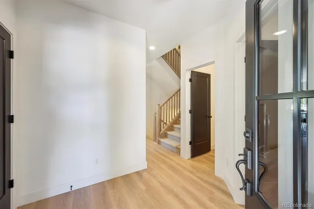 a view of a hallway with wooden floor and entryway