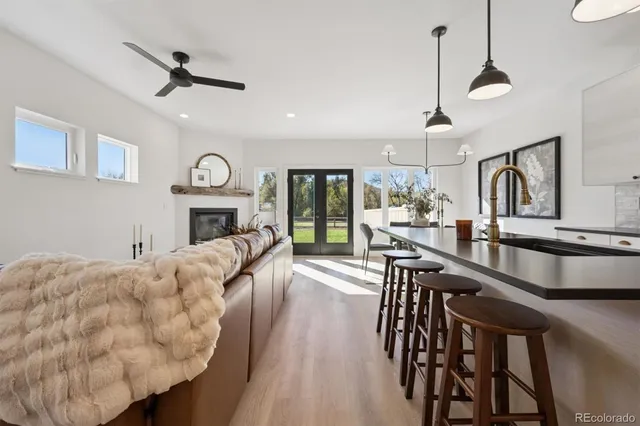 a living room with furniture fireplace and a window