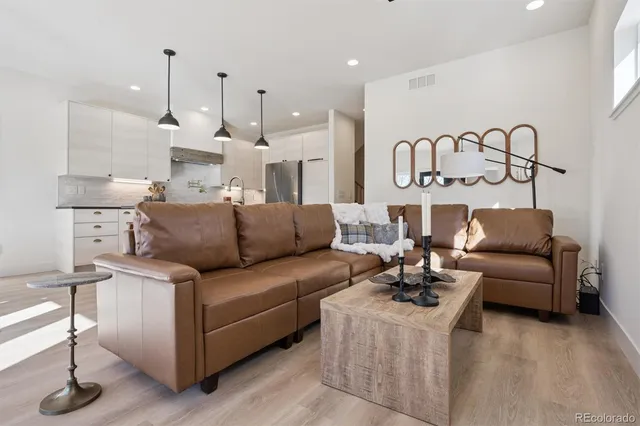 a living room with furniture and kitchen view