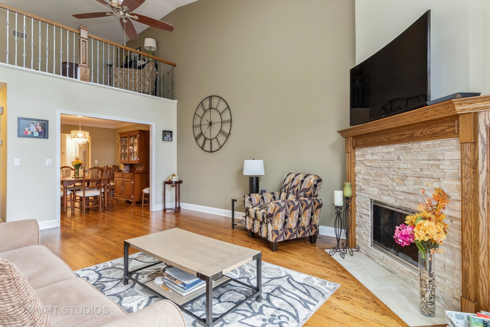 14520 Lake Ridge Road Orland Park, IL 60462 - Photo 3 of 16 a living room with furniture a flat screen tv and a fireplace