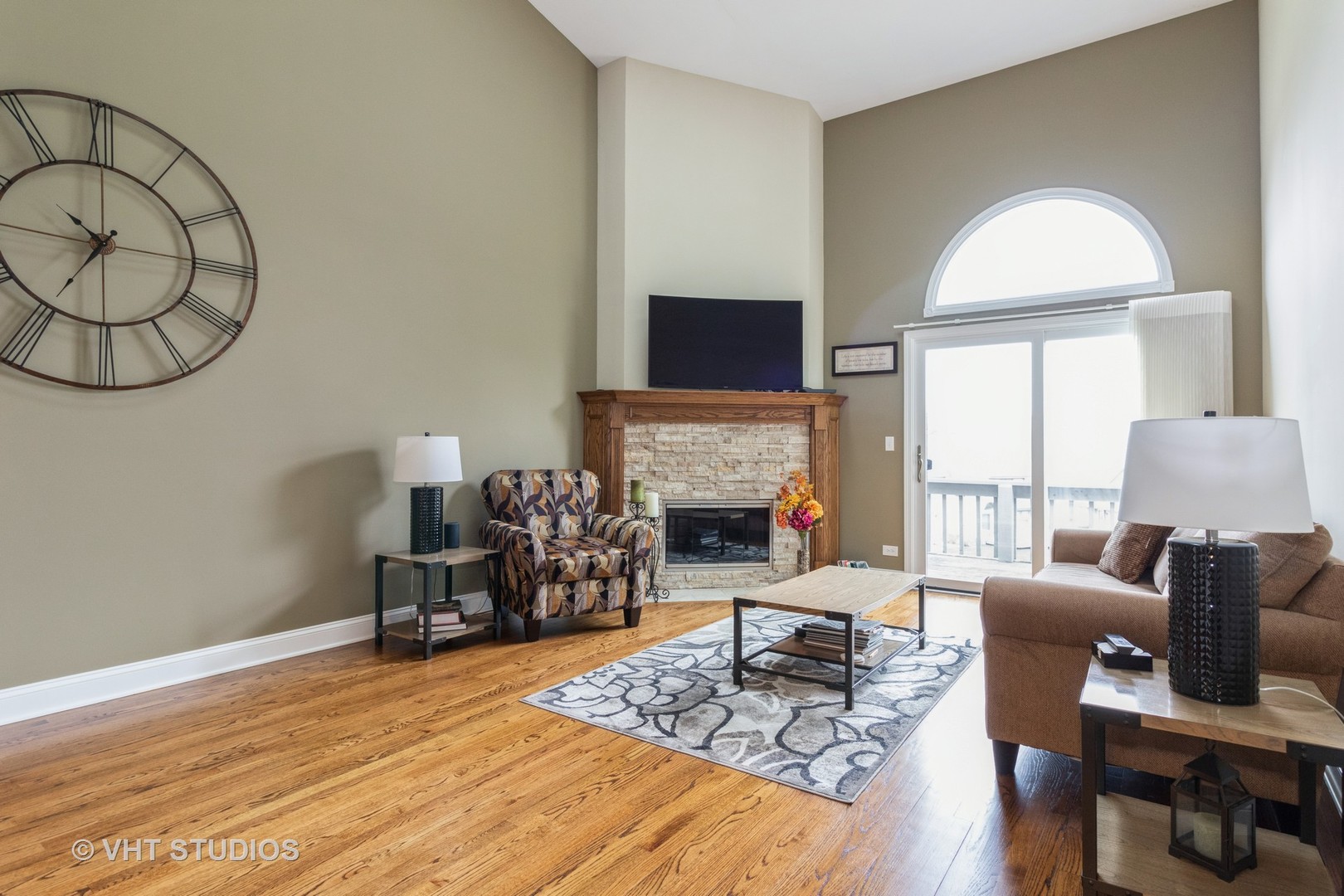14520 Lake Ridge Road Orland Park, IL 60462 - Photo 4 of 16 a living room with furniture a fireplace and a flat screen tv