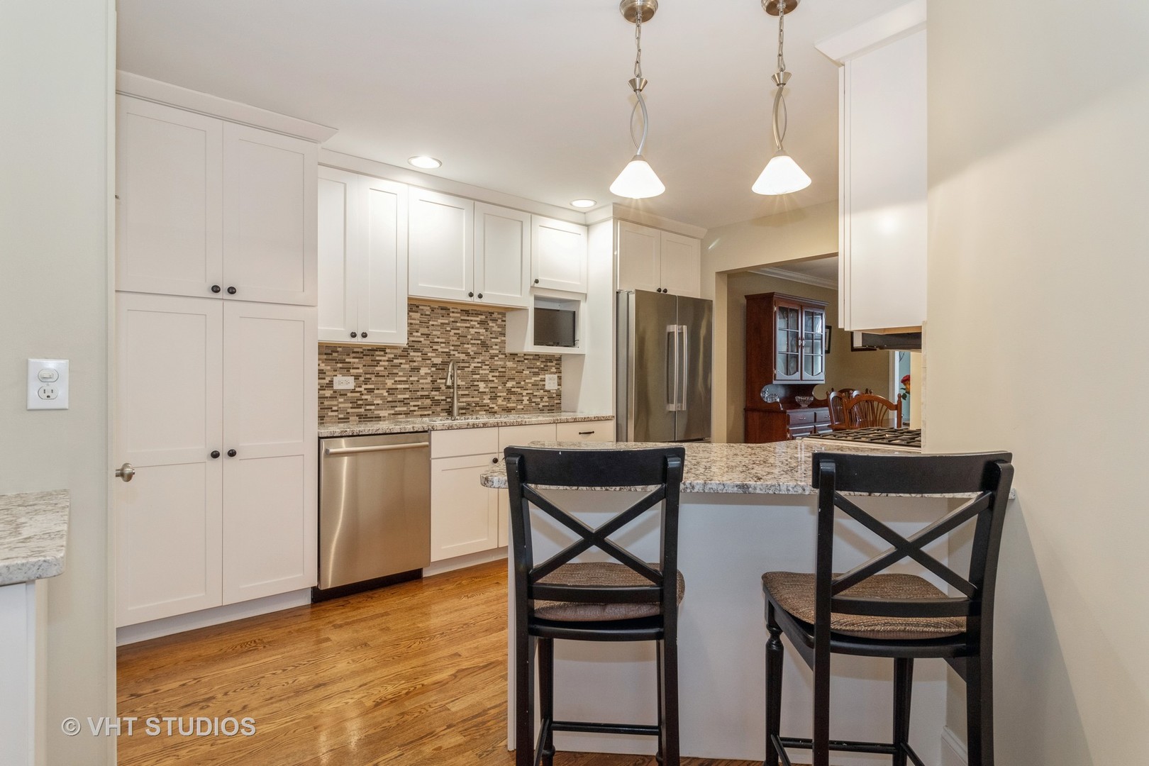 14520 Lake Ridge Road Orland Park, IL 60462 - Photo 5 of 16 a kitchen with stainless steel appliances kitchen island granite countertop a stove a sink and a refrigerator