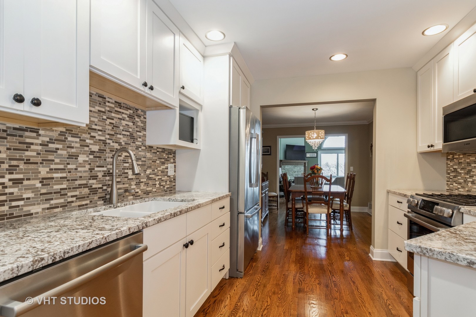 14520 Lake Ridge Road Orland Park, IL 60462 - Photo 6 of 16 a kitchen with granite countertop a counter space dining table and stainless steel appliances