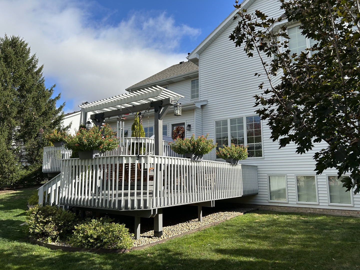 2006 Woodbine Road Bloomington, IL 61704 - Photo 17 of 98 a view of a house with a deck and a yard