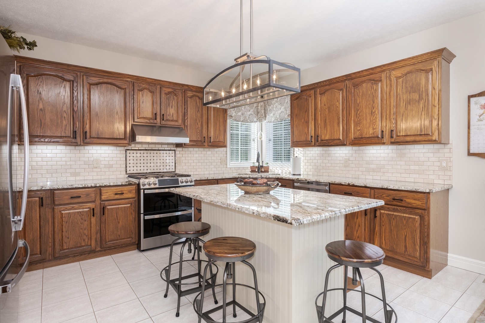 2006 Woodbine Road Bloomington, IL 61704 - Photo 39 of 98 a kitchen with stainless steel appliances granite countertop a stove a sink dishwasher and cabinets with wooden floor