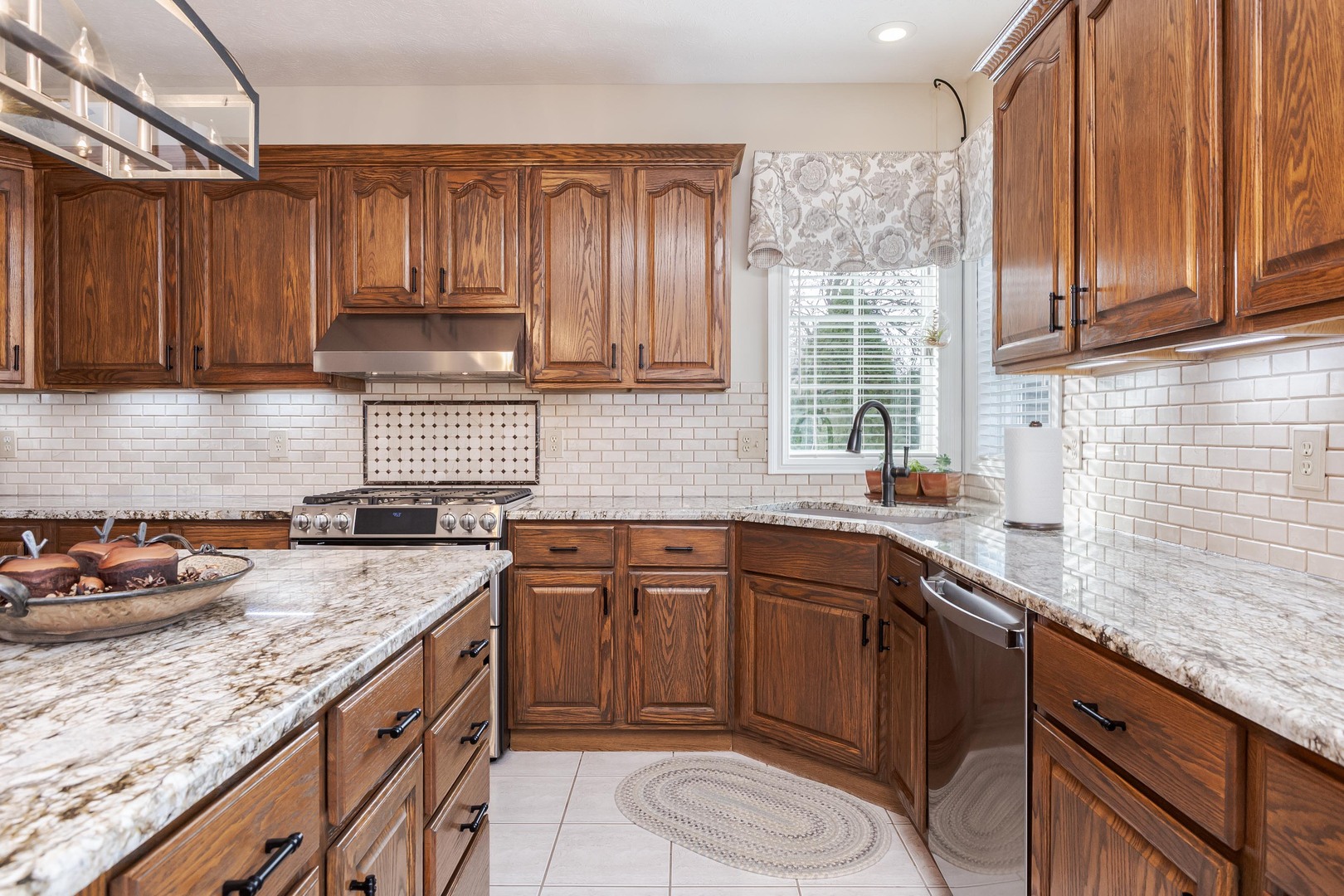 2006 Woodbine Road Bloomington, IL 61704 - Photo 40 of 98 a kitchen with stainless steel appliances granite countertop wooden cabinets a sink and dishwasher