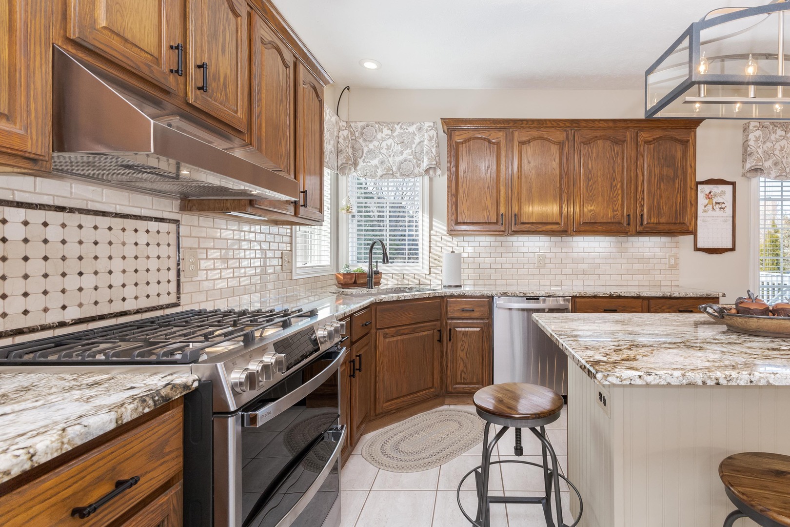 2006 Woodbine Road Bloomington, IL 61704 - Photo 43 of 98 a kitchen with granite countertop a sink stove and cabinets