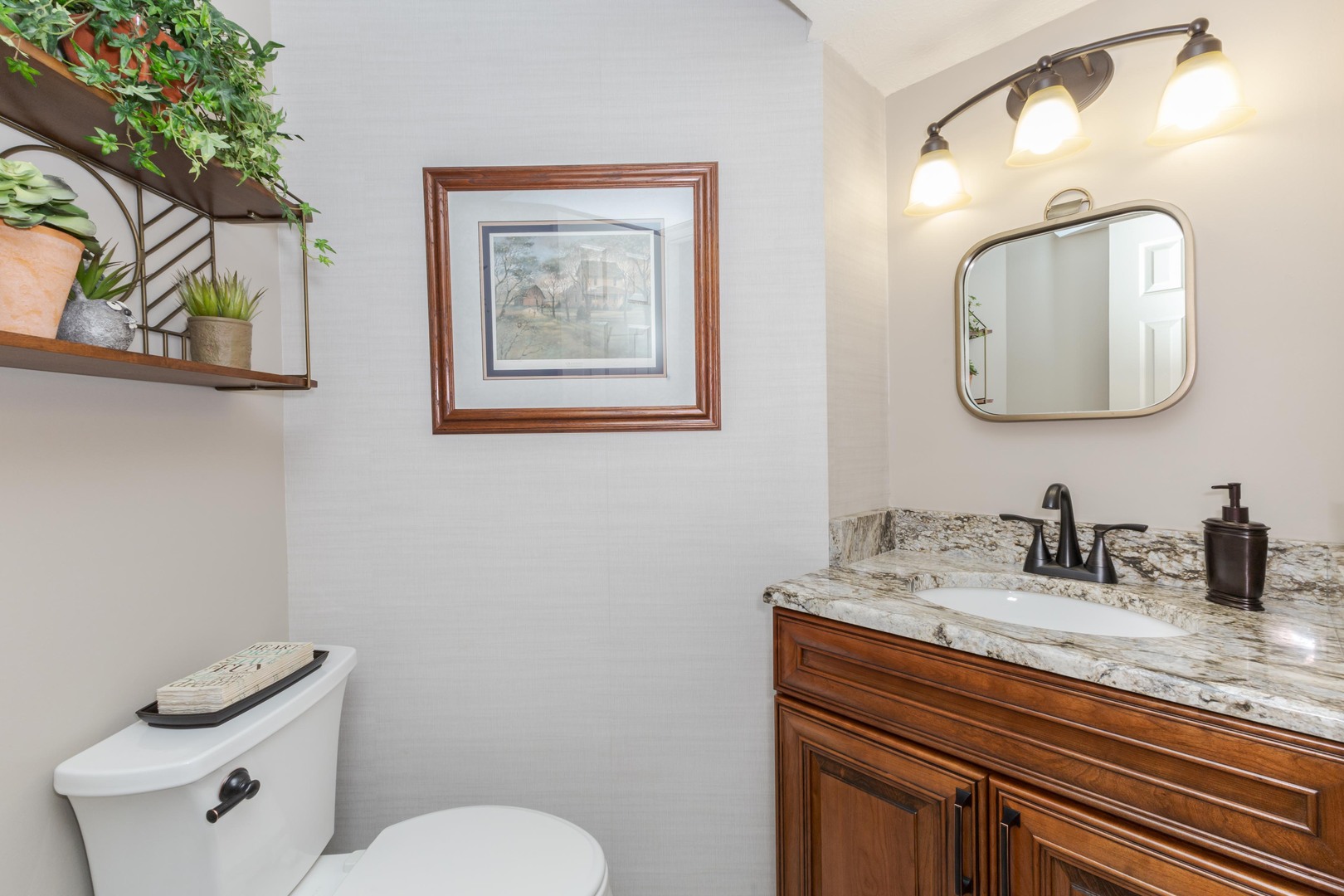 2006 Woodbine Road Bloomington, IL 61704 - Photo 75 of 98 a bathroom with a toilet sink and mirror