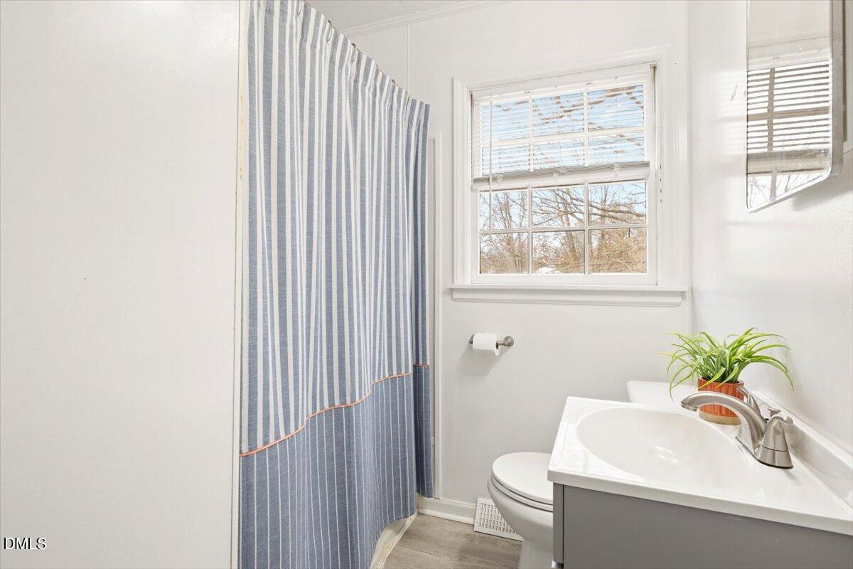 1719 Lawrence Road Hillsborough, NC 27278 - Photo 13 of 24 a bathroom with a sink a toilet and a mirror