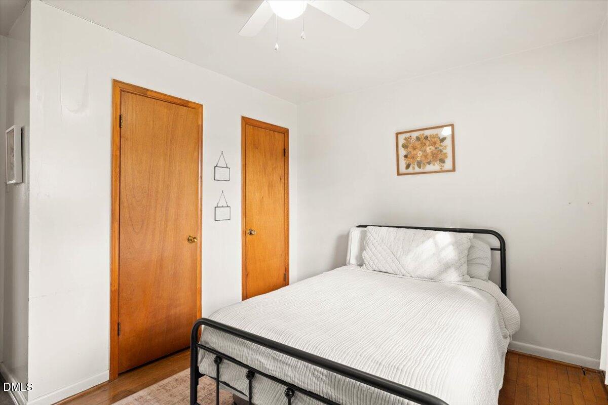 1719 Lawrence Road Hillsborough, NC 27278 - Photo 16 of 24 a bedroom with a bed and wooden floor