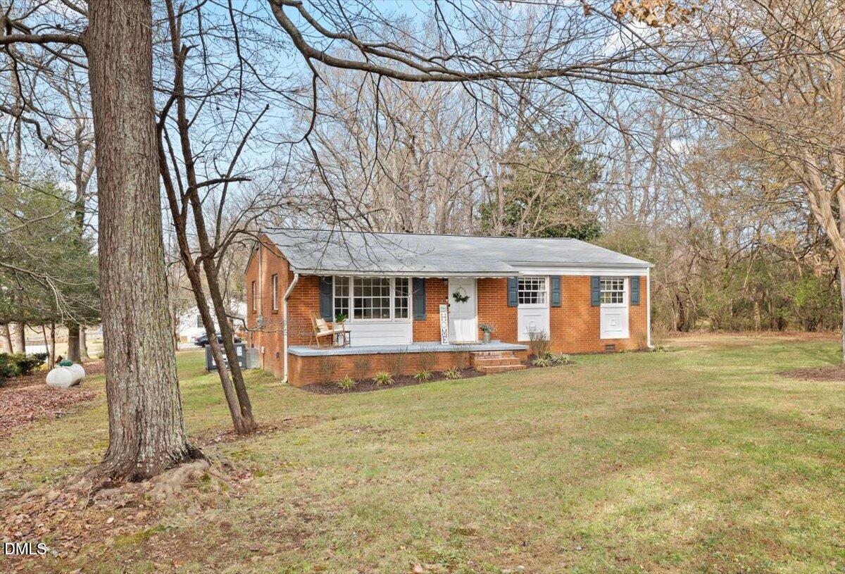 1719 Lawrence Road Hillsborough, NC 27278 - Photo 2 of 24 a front view of a house with a yard