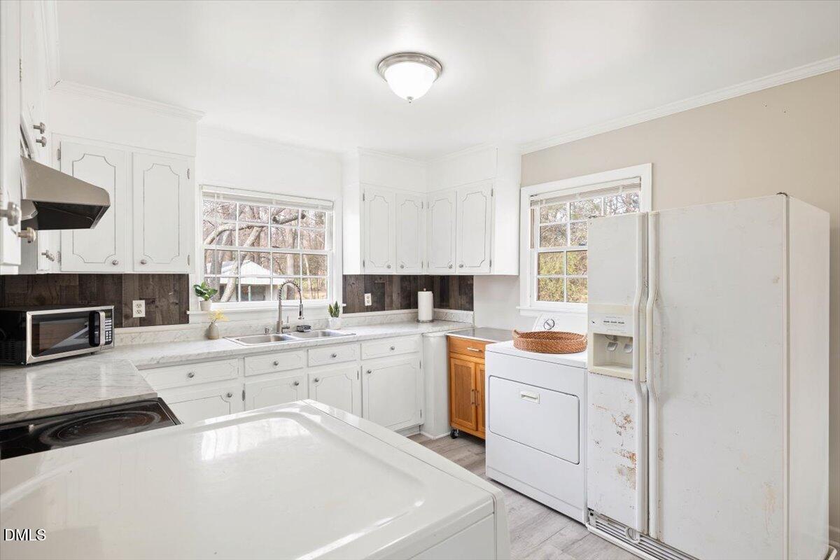1719 Lawrence Road Hillsborough, NC 27278 - Photo 7 of 24 a kitchen with a stove white refrigerator sink and cabinets