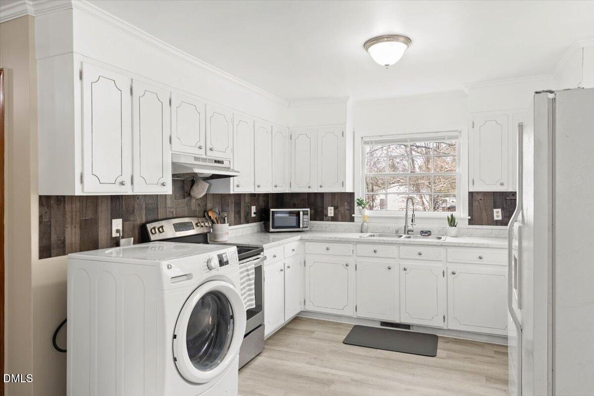 1719 Lawrence Road Hillsborough, NC 27278 - Photo 8 of 24 a view of a kitchen with stainless steel appliances granite countertop a sink and cabinets