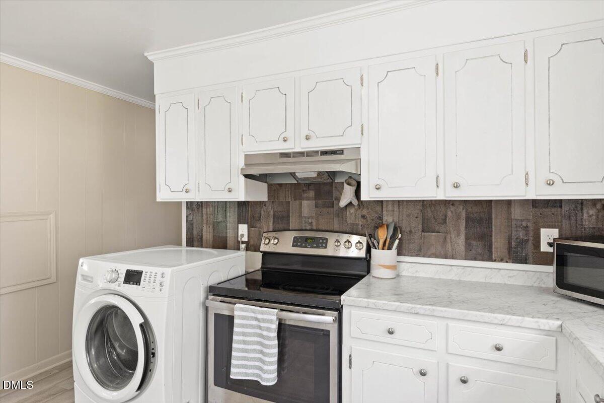 1719 Lawrence Road Hillsborough, NC 27278 - Photo 9 of 24 a kitchen with white cabinets and appliances