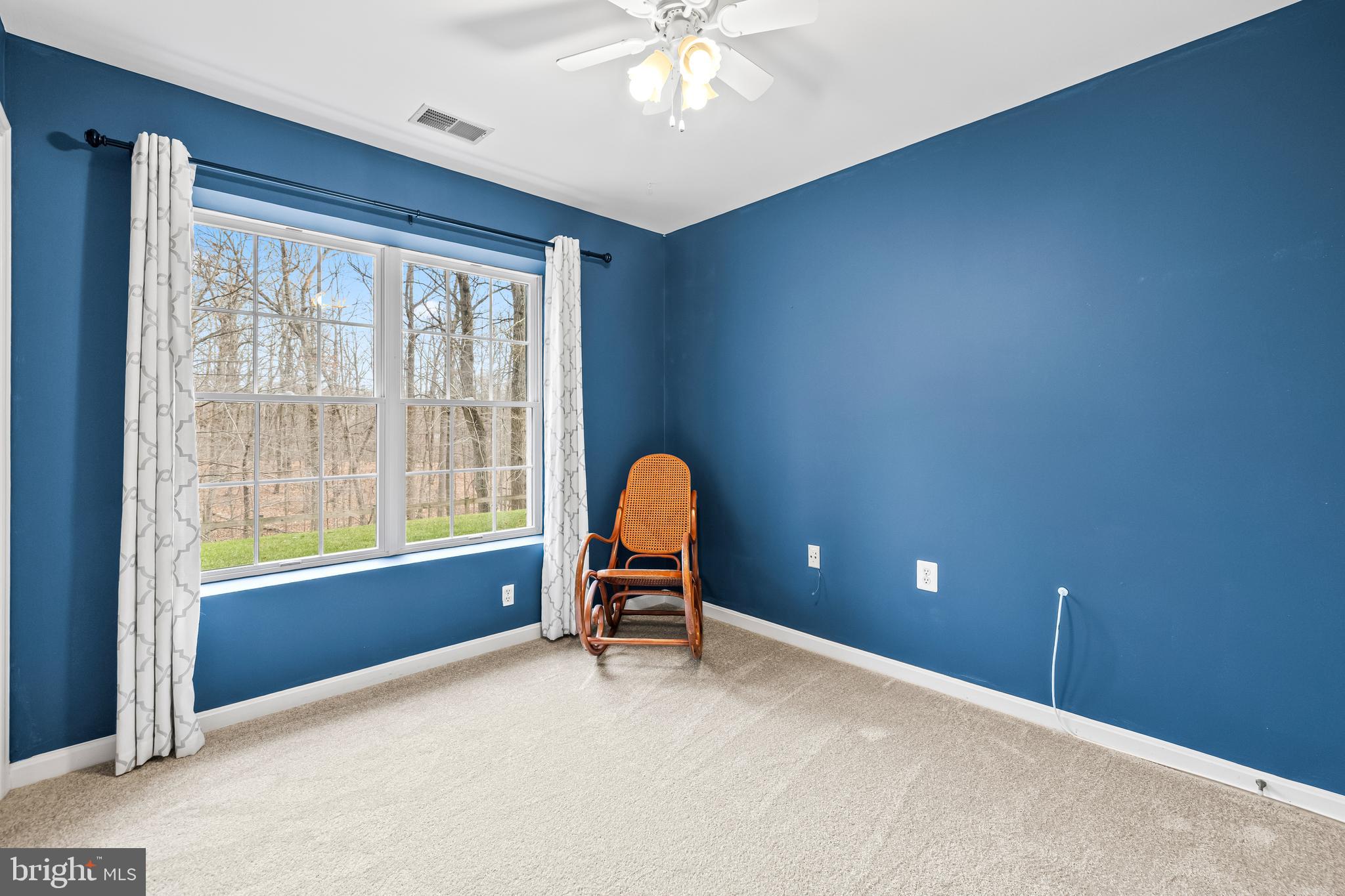 12011 Tralee Road, Unit 104 Lutherville-Timonium, MD 21093 - Photo 15 of 33 a view of a livingroom with a ceiling fan and window