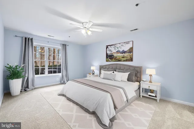 a bedroom with a large bed and a window