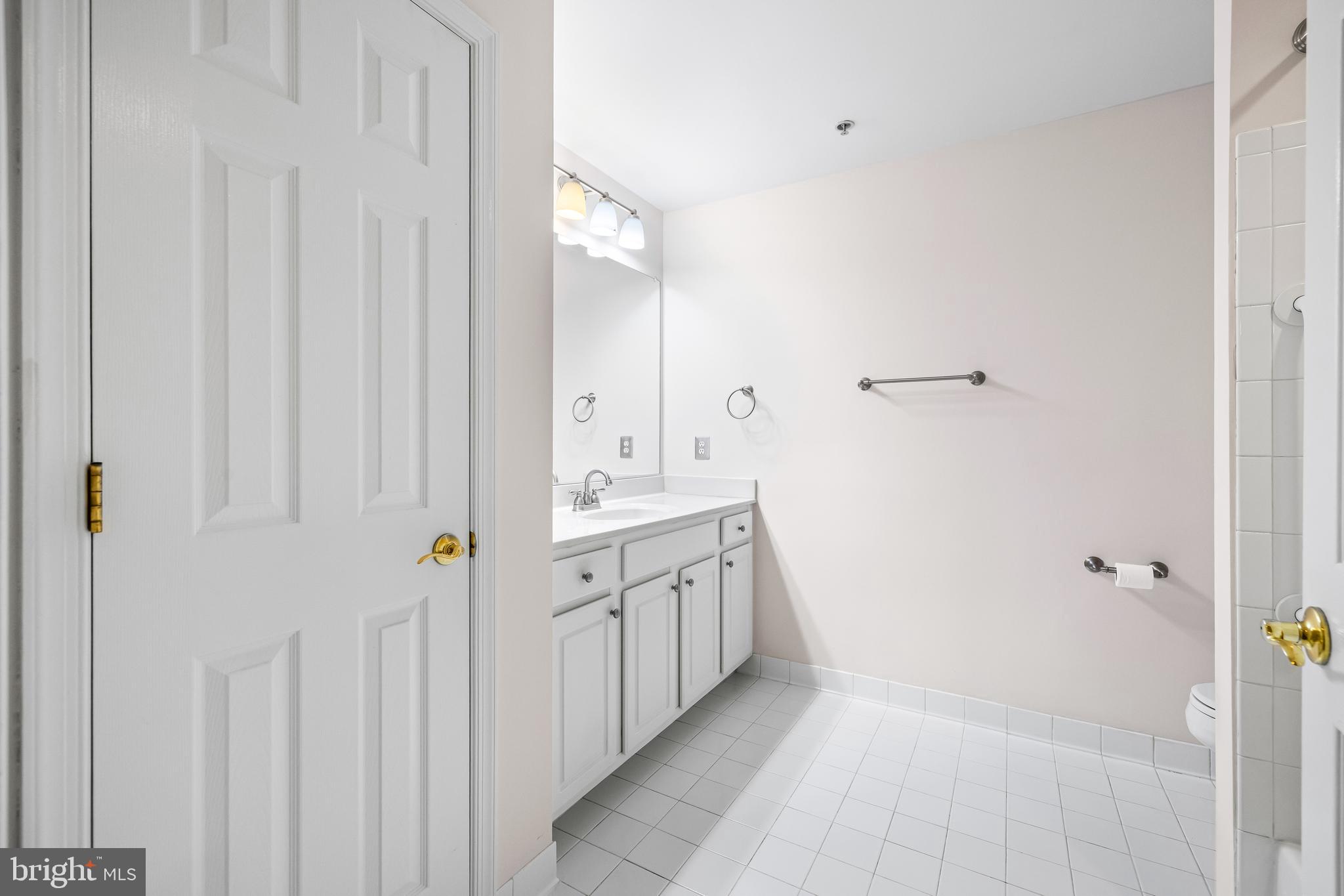 12011 Tralee Road, Unit 104 Lutherville-Timonium, MD 21093 - Photo 24 of 33 a bathroom with a double vanity sink and mirror