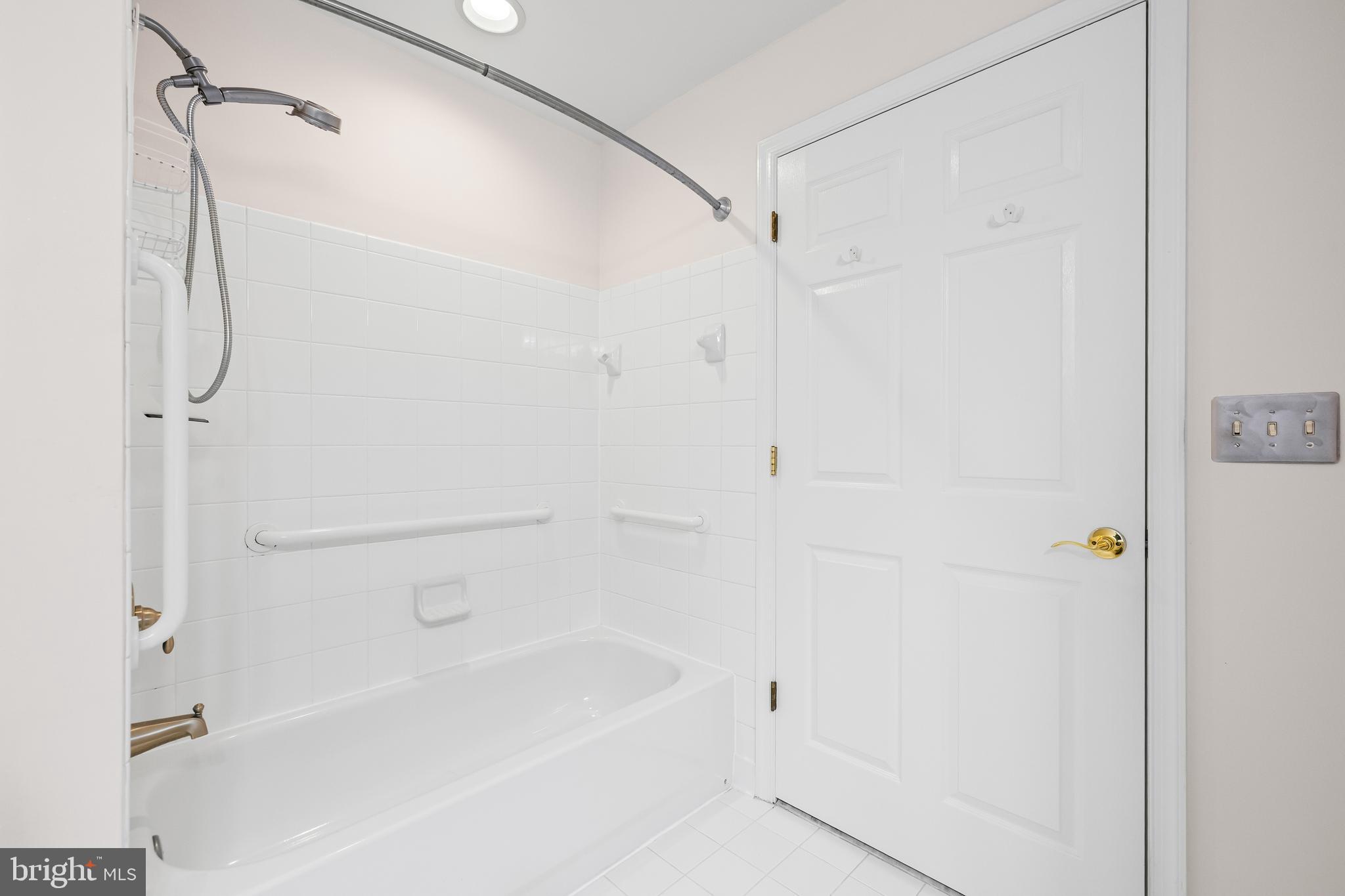 12011 Tralee Road, Unit 104 Lutherville-Timonium, MD 21093 - Photo 25 of 33 a bathroom with a bathtub and a shower