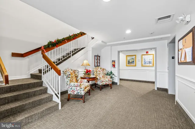 a living room with furniture and stairs