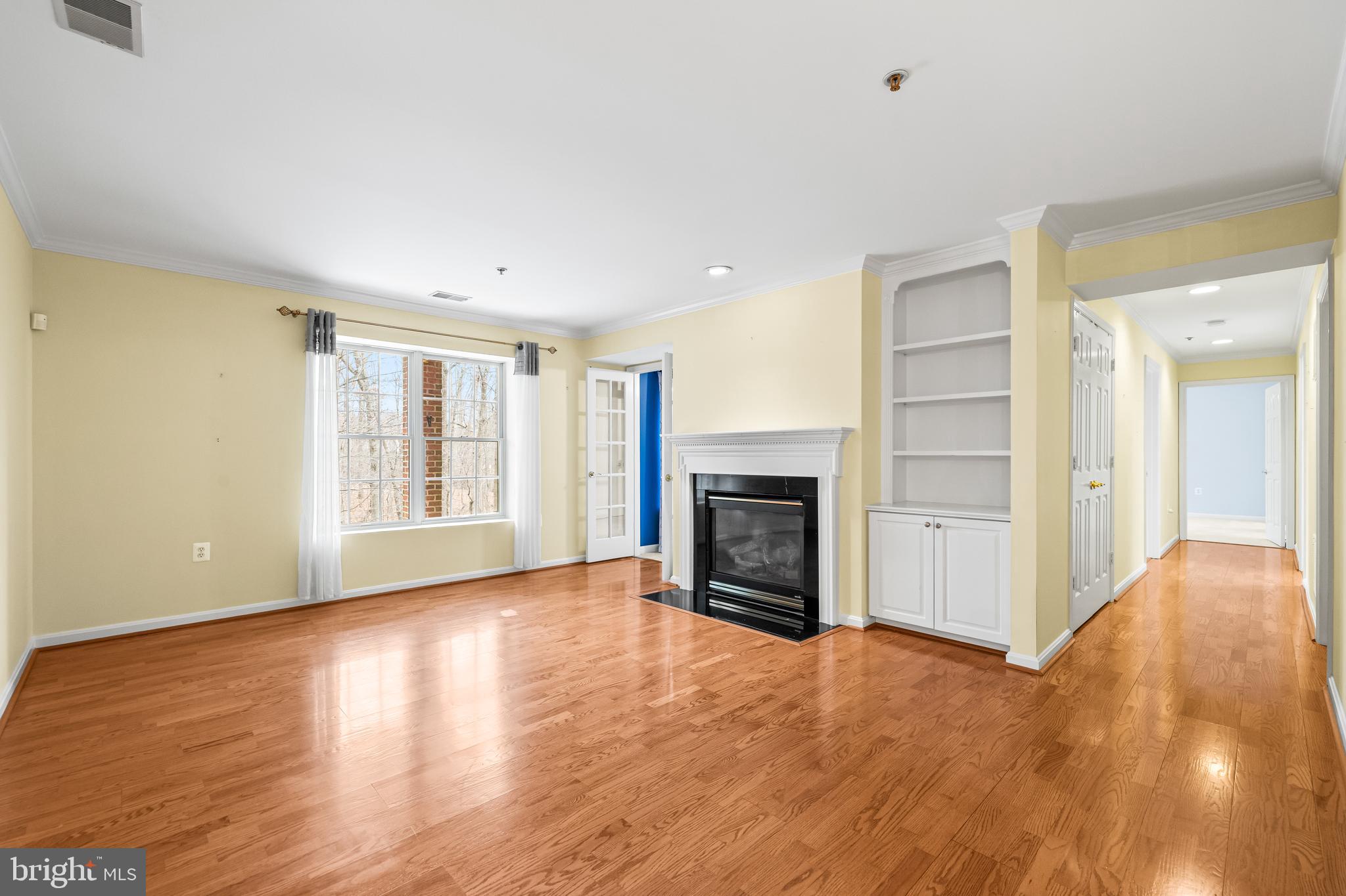 12011 Tralee Road, Unit 104 Lutherville-Timonium, MD 21093 - Photo 4 of 33 a view of an empty room with window and fire place