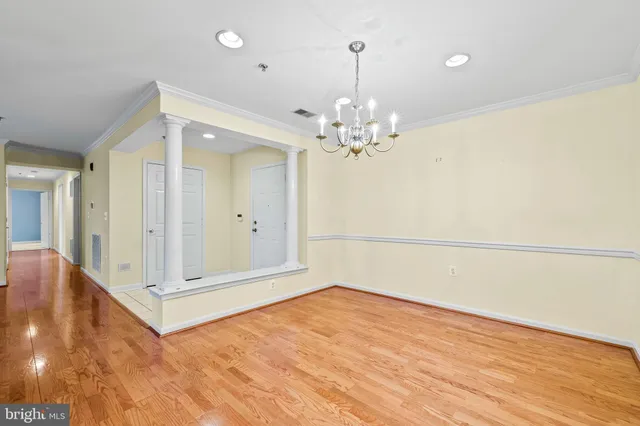 a view of a room with wooden floor