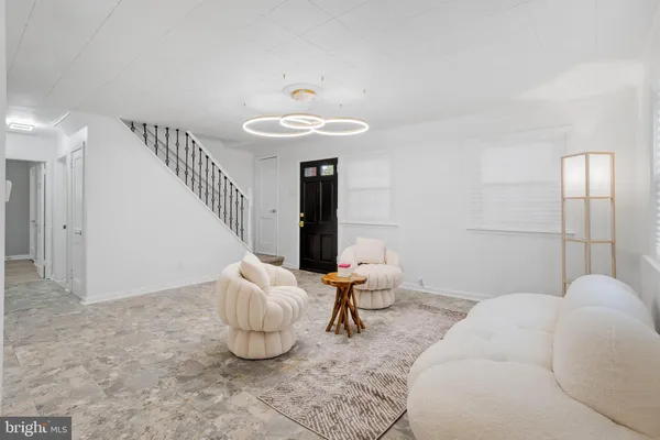 a living room with furniture and a chandelier