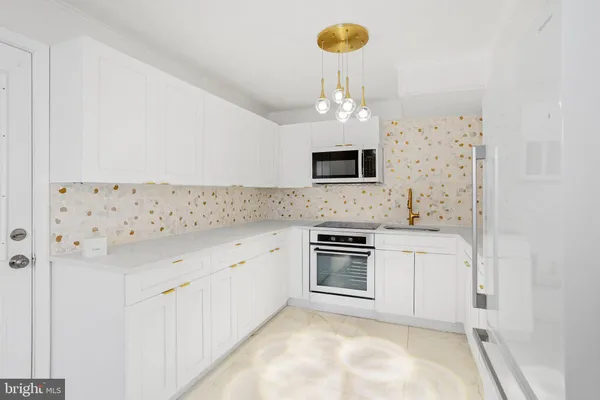 a kitchen with stainless steel appliances a stove sink and refrigerator