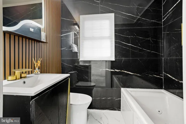 a bathroom with a sink a toilet and bathtub