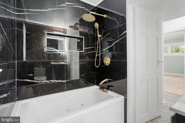 a bathroom with a bathtub and a shower