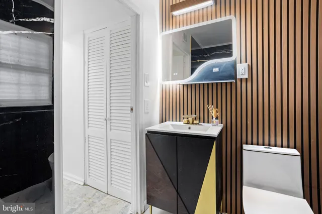 a bathroom with a toilet sink and mirror