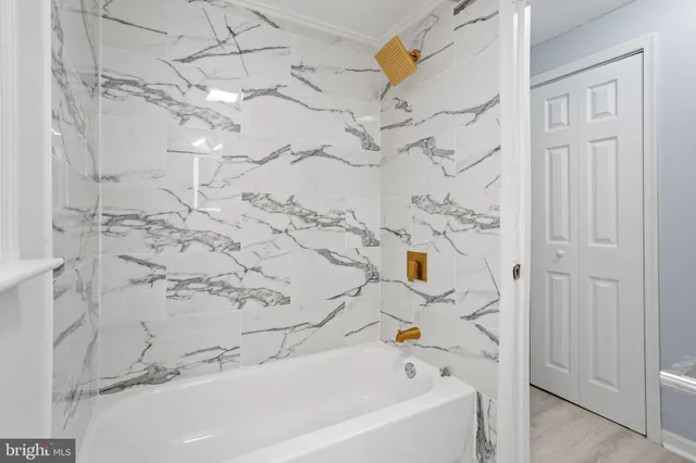 a bathroom with a bathtub and shower