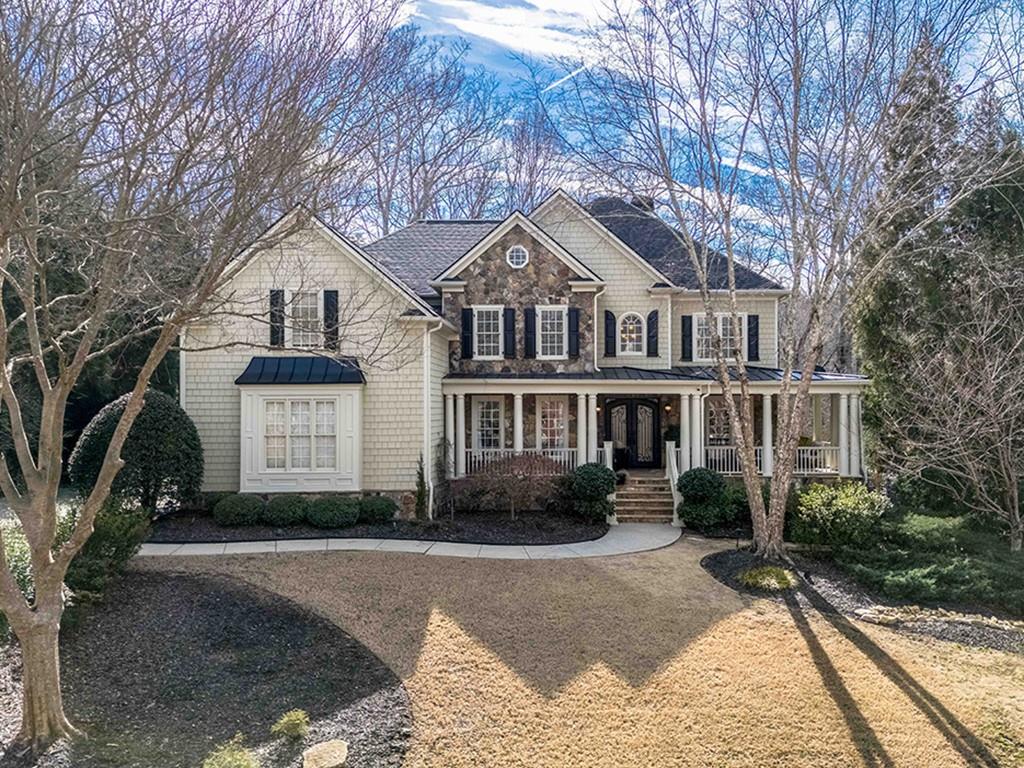 1635 Reddstone Cl Milton, GA 30004 - Photo 1 of 1 a front view of a house with a yard and garage