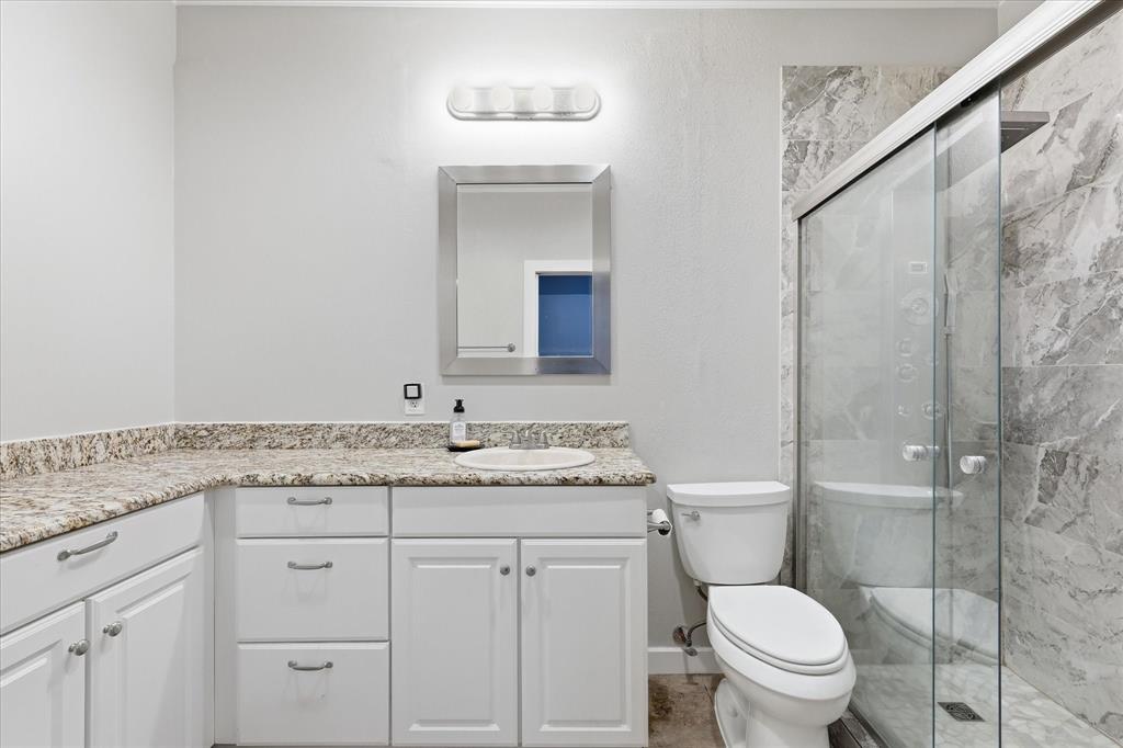 14277 Preston Road, Unit 615 Dallas, TX 75254 - Photo 15 of 20 a bathroom with a granite countertop sink toilet and shower