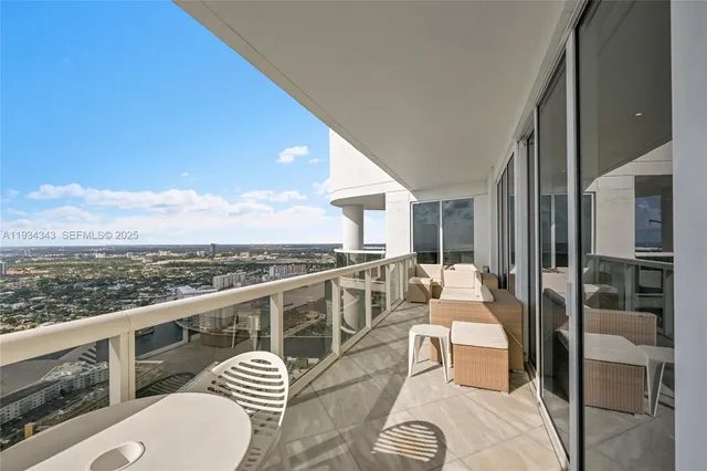 a balcony with furniture and a potted plant