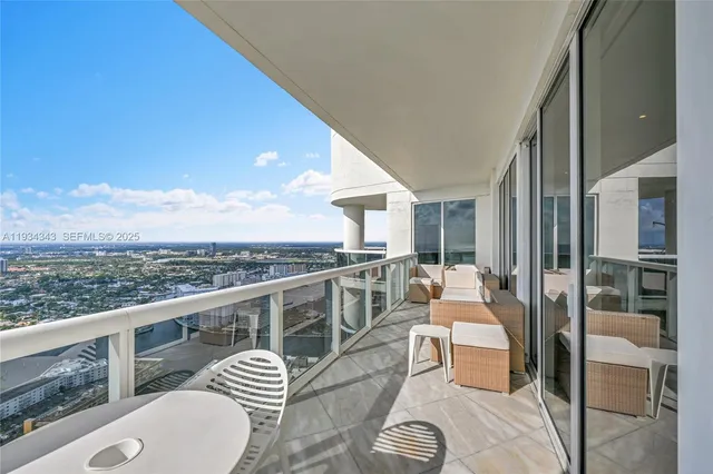 a view of a balcony with chair and a floor to ceiling window