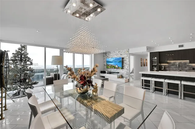 a living room with fireplace furniture and a large window