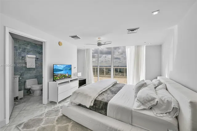 a bedroom with a bed and a large window