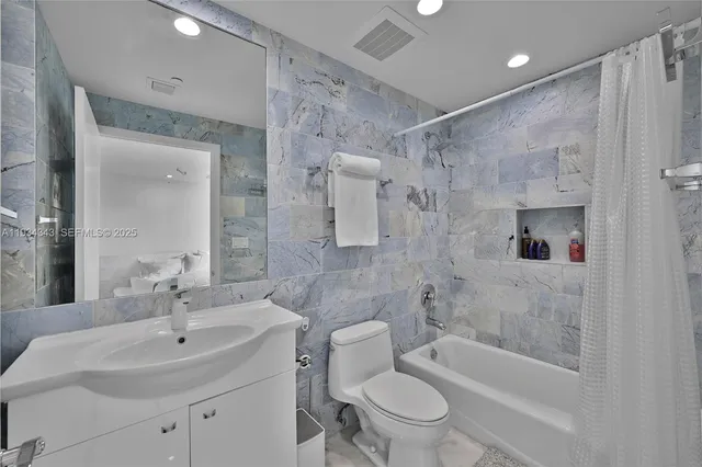 a large bedroom with a large bed and a large window