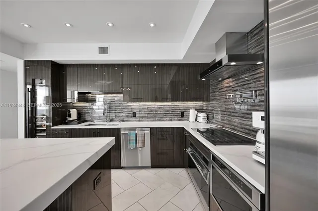 a kitchen with stainless steel appliances granite countertop a sink and stove top oven