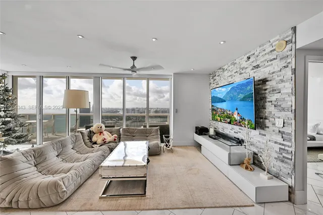 a living room with furniture large window and a flat screen tv