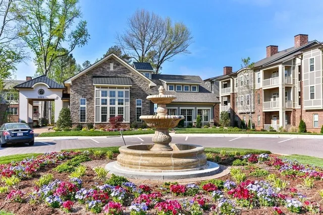 a front view of a house with a yard fountain and a fountain