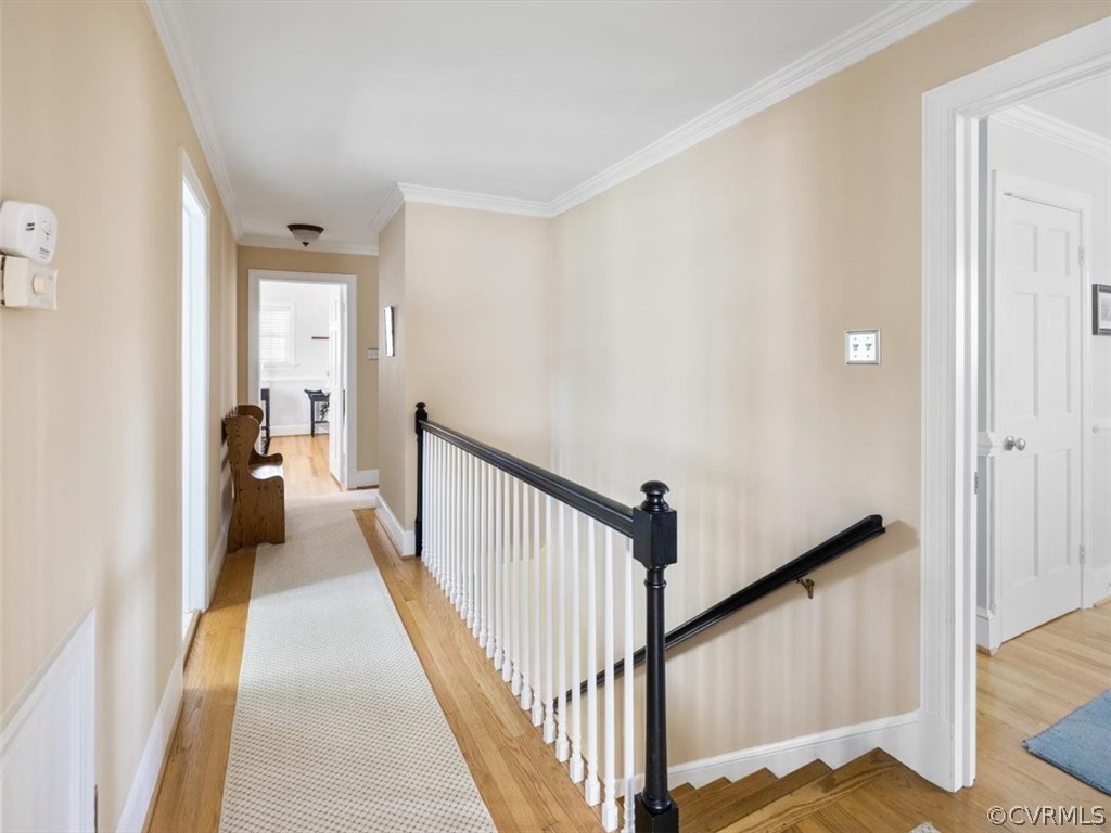 2931 West Brigstock Road Midlothian, VA 23113 - Photo 20 of 46 a view of a hallway to a livingroom with wooden floor and stairs