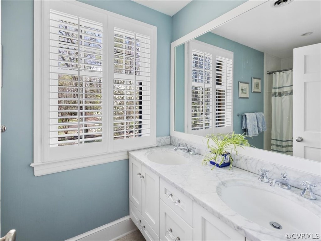 2931 West Brigstock Road Midlothian, VA 23113 - Photo 21 of 46 a bathroom with a granite countertop sink and a window