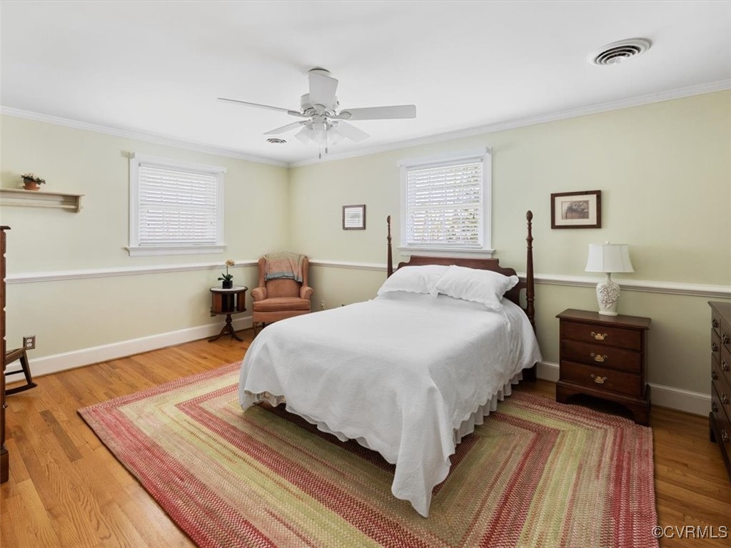 2931 West Brigstock Road Midlothian, VA 23113 - Photo 26 of 46 a bedroom with a bed and wooden floor