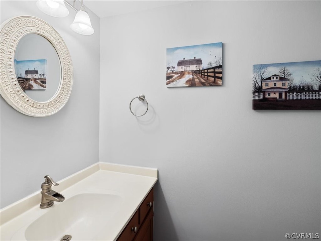 2931 West Brigstock Road Midlothian, VA 23113 - Photo 30 of 46 a bathroom with a sink and a mirror